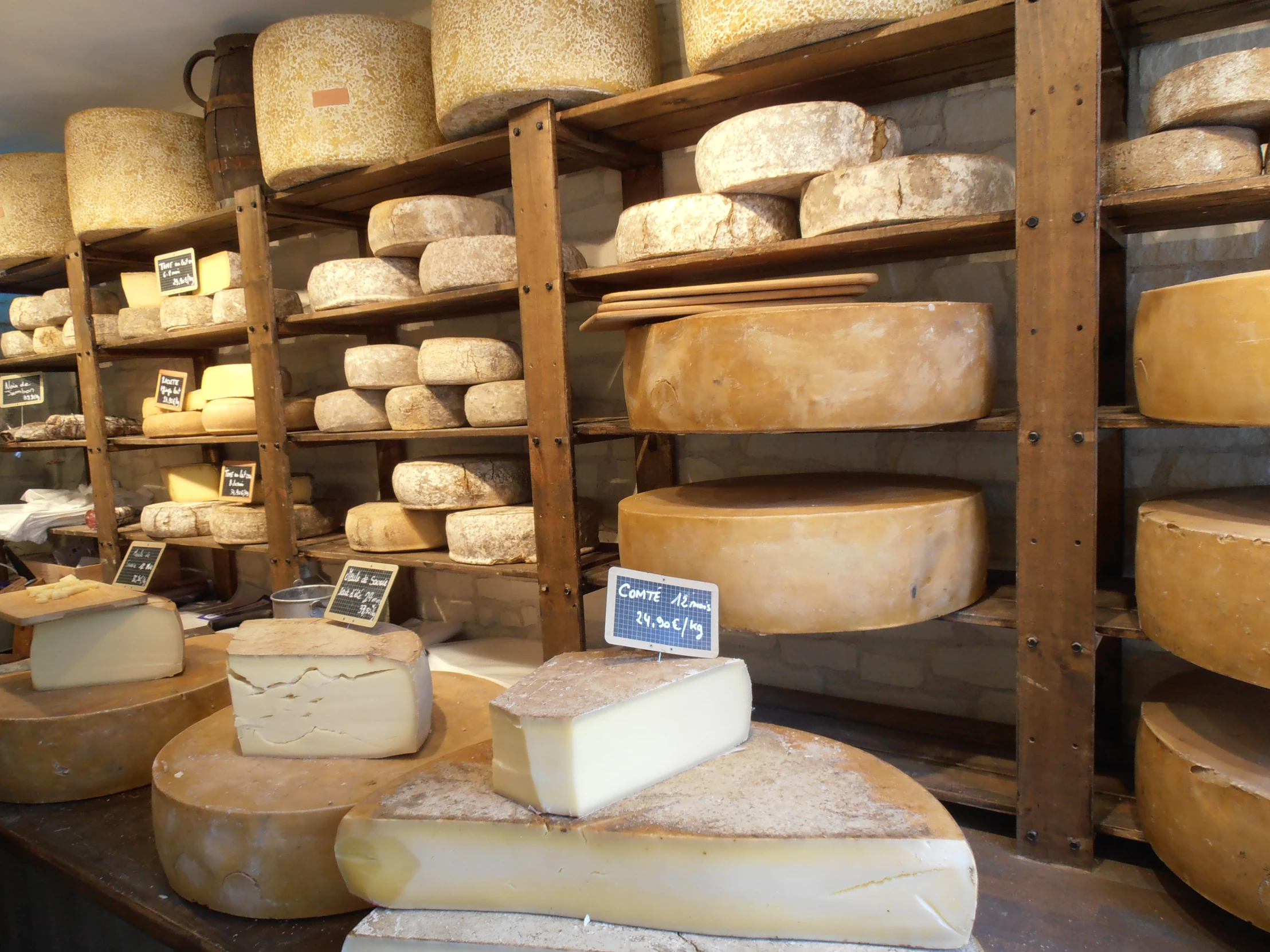 a wide selection of cheese is on display in a store