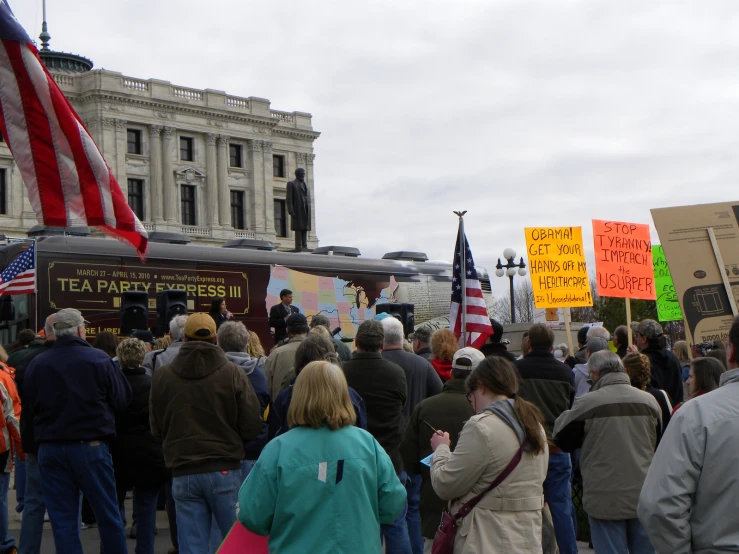 people walking outside near a food truck with protest signs