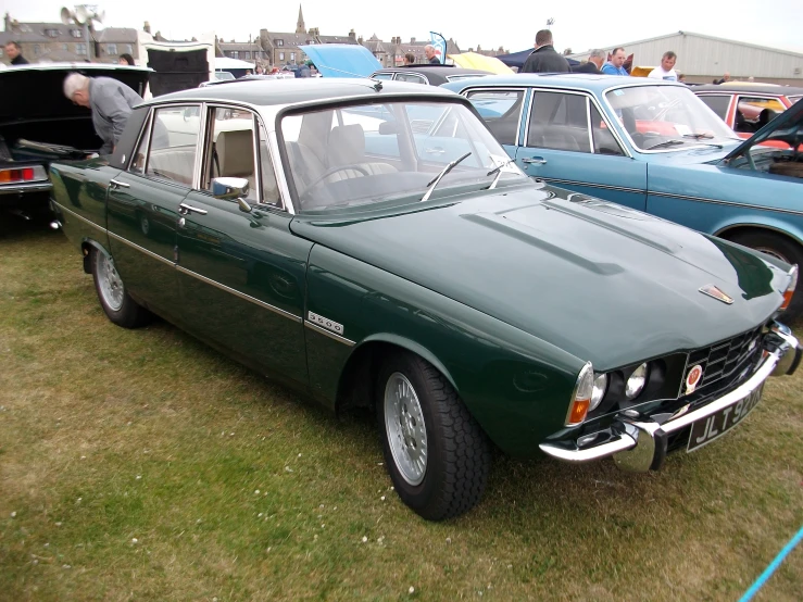 a group of old, vintage and antique cars on display