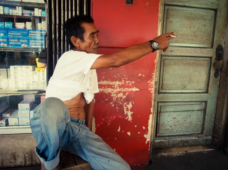 a man points at the door of a store