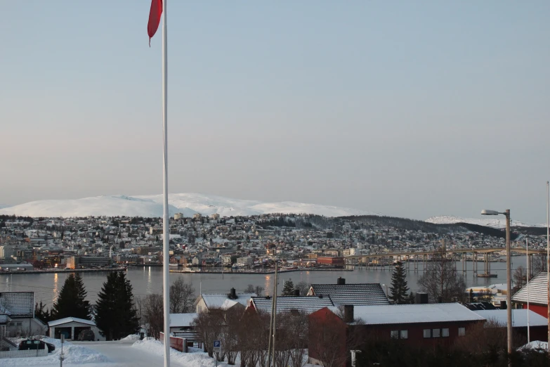 a town by the water with a canadian flag blowing in the wind