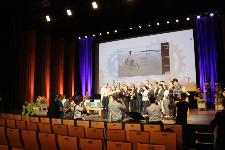 a group of people are on the stage to speak