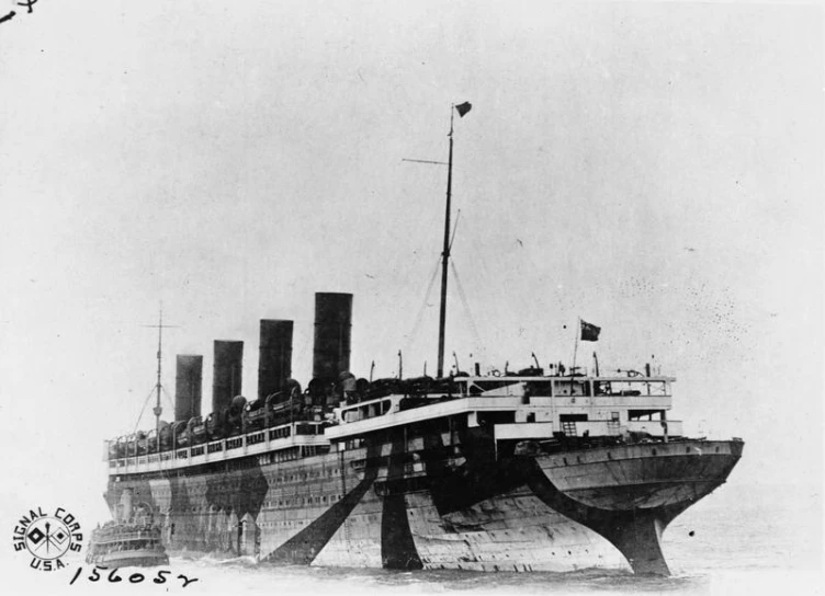 a big boat sitting in the water with a sky background