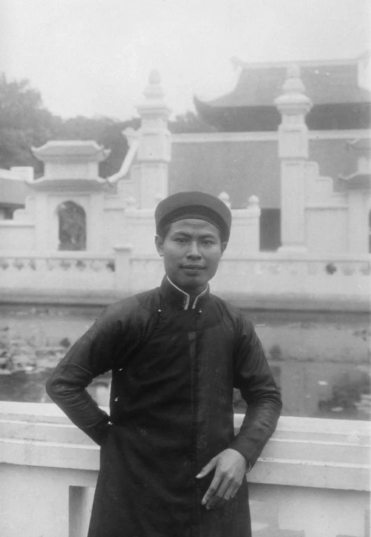 an old picture of a man standing on a bridge