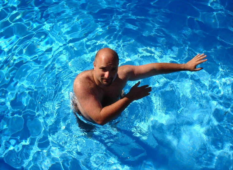 a bald man in the pool wearing 