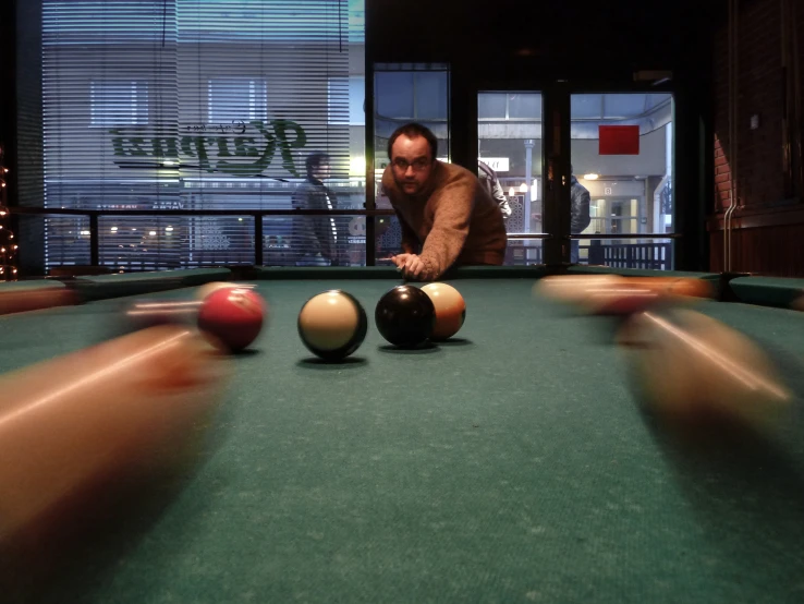 some pool balls sitting on top of a green table