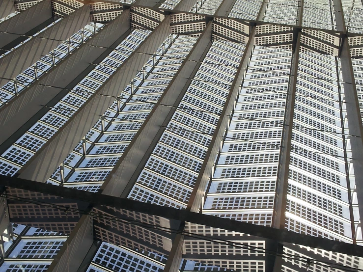 looking up at a glass roof structure on the street