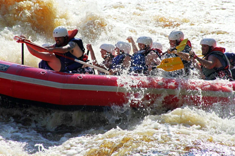 a group of people are on a boat in the water