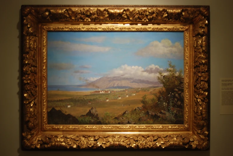 a large painting hanging in a frame in a room