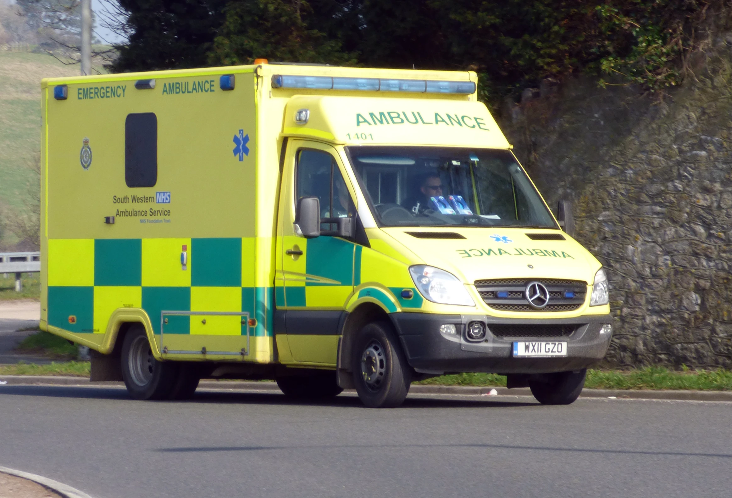 an ambulance is parked at the side of a road