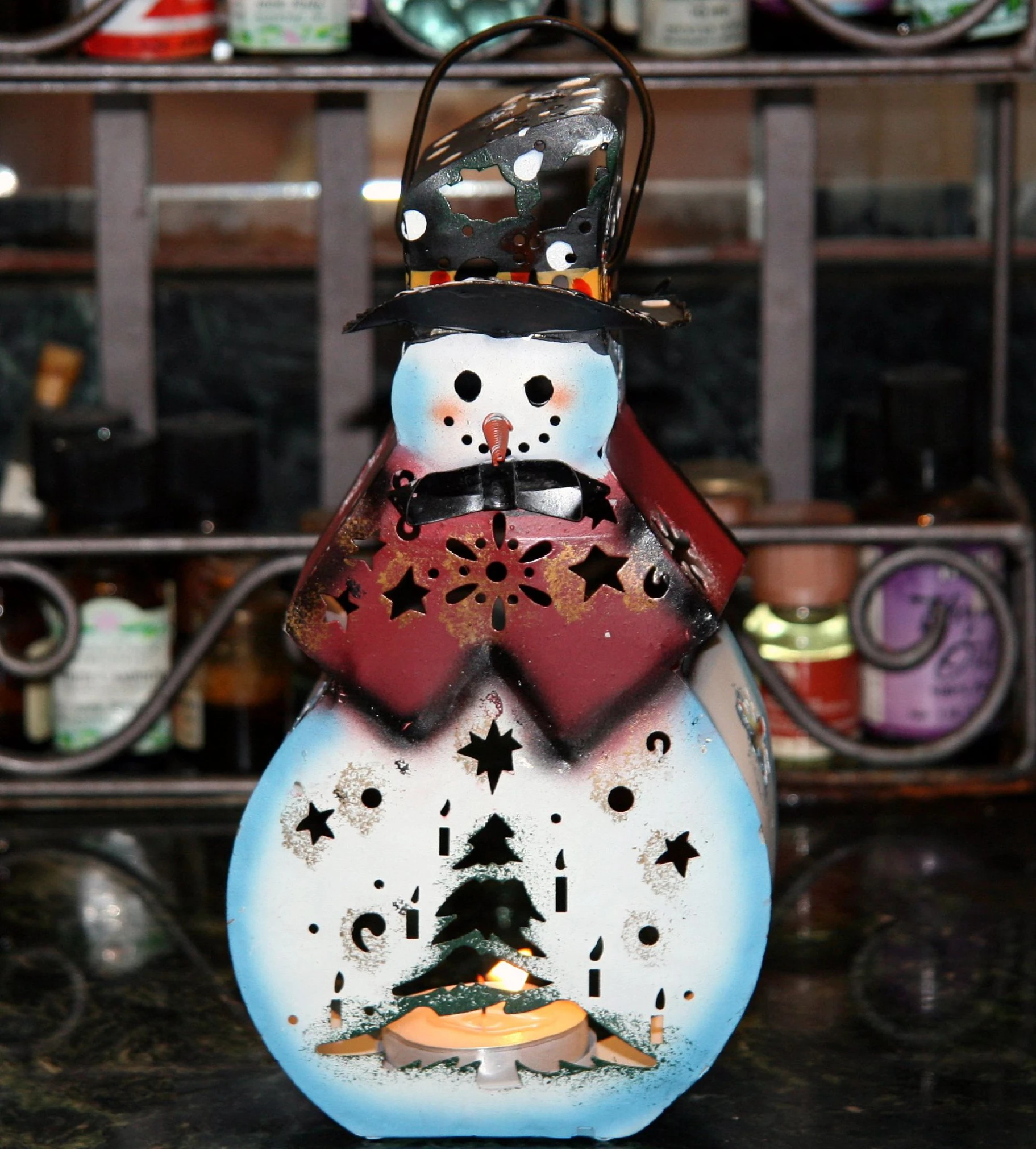 a snowman statue on top of a table with lights