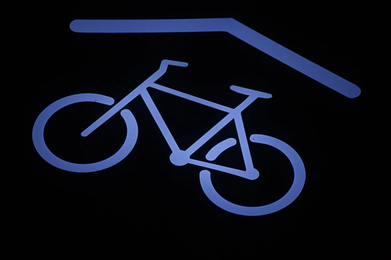 a bicycle is silhouetted against a dark night sky
