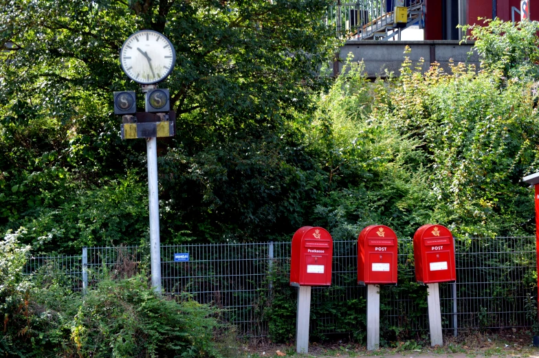 a group of post office next to a street clock