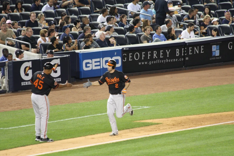 two baseball players are walking on the field