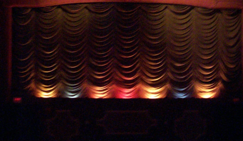 a lit up screen sits behind a stage