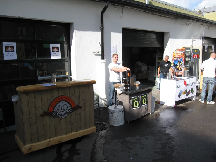 men are standing at the front of a business selling equipment