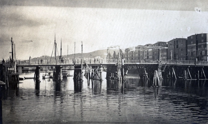 a city skyline with water and a bridge