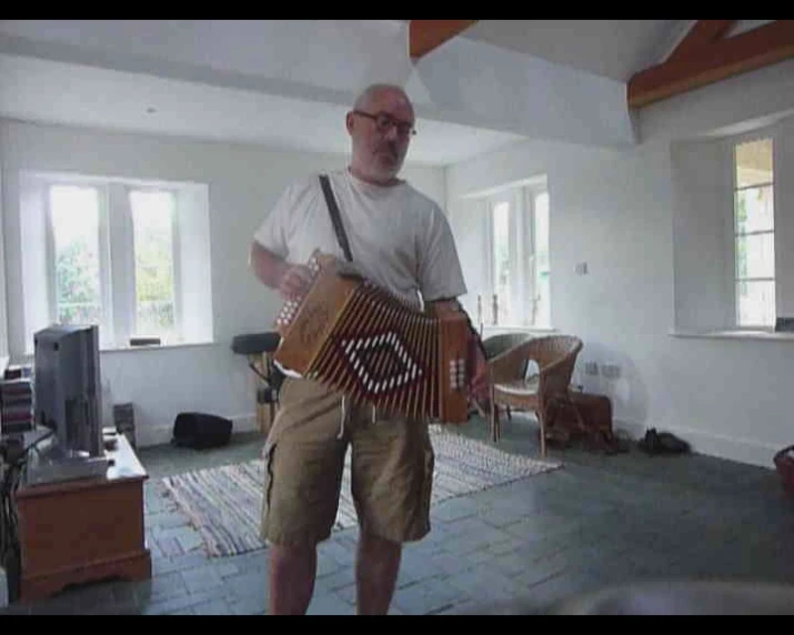 an old man holding an accordion in his hands