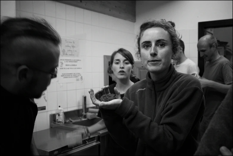 a woman with one hand in a small bathroom