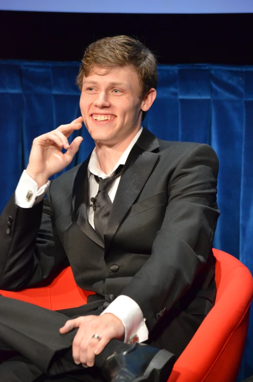 a man in a suit smoking a cigarette