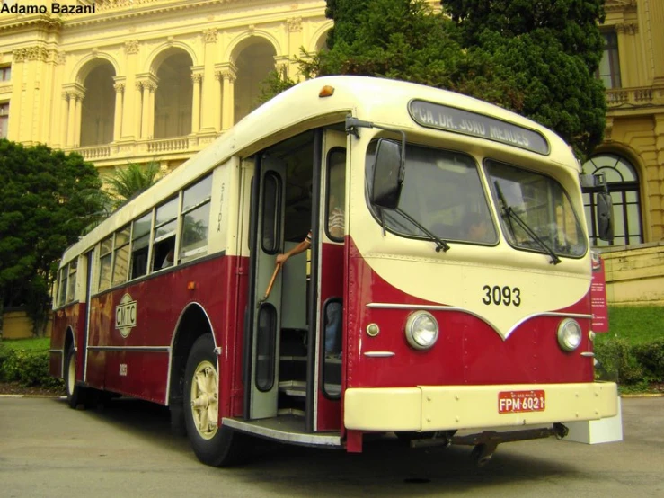 a bus parked on a city street in front of a building