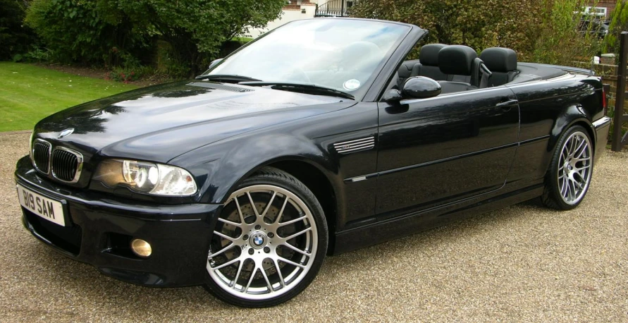 a bmw z3 convertible is parked outside