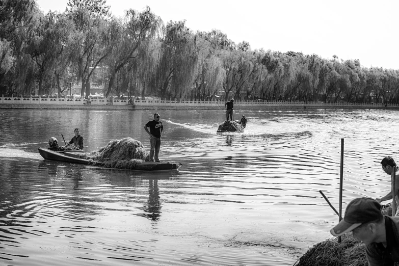 men standing in a canoe on a lake