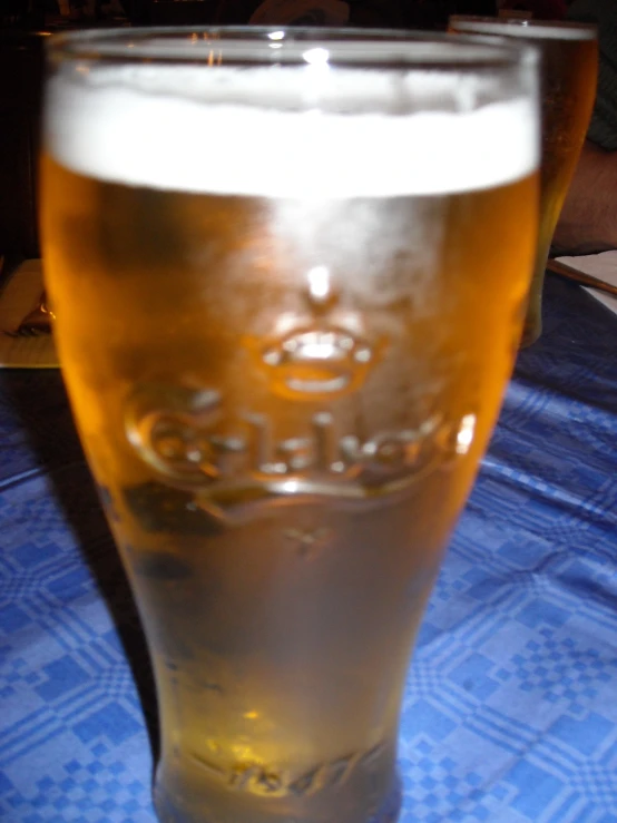 a glass of beer that is sitting on a table