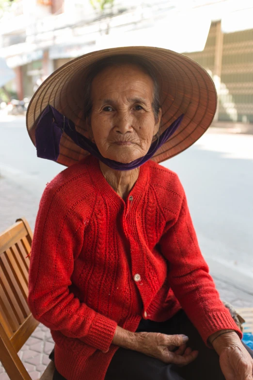 an elderly woman wearing a large hat