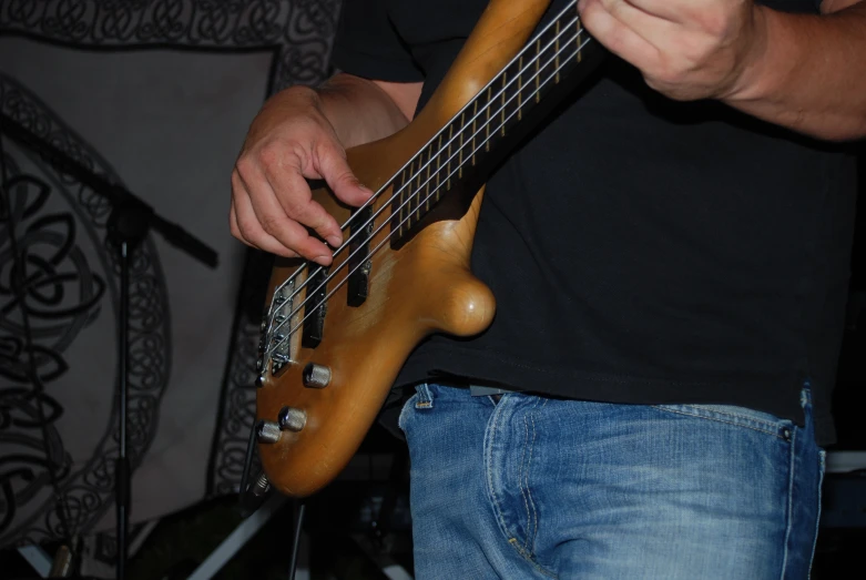 a man holding a guitar strap with his hand