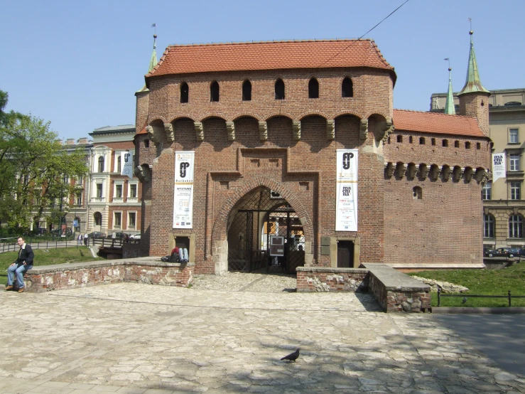 a large brick gate in the middle of the city