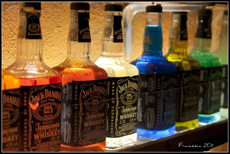 bottles in a row of various colored bottles