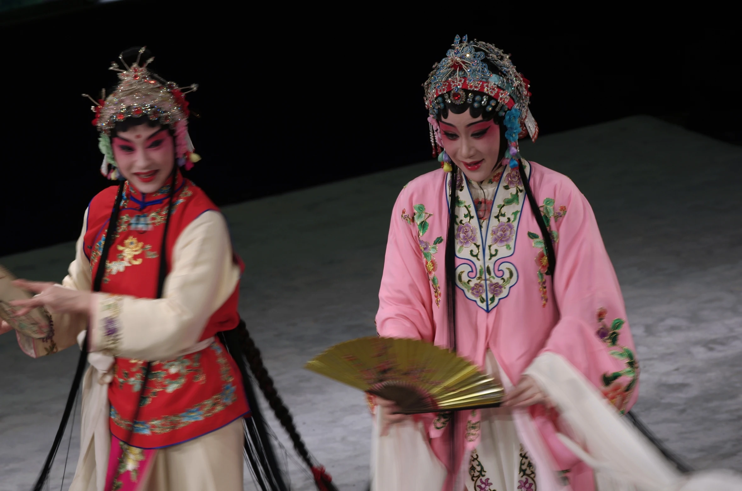 two young women in costume performing on stage