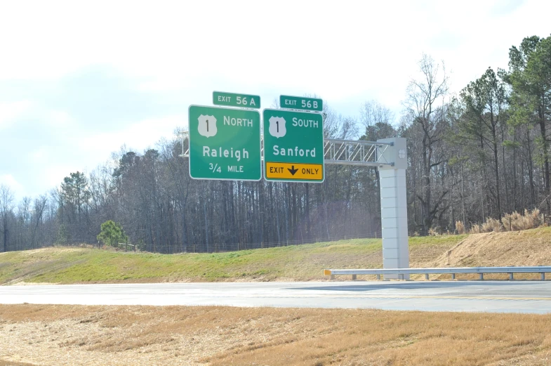 street signs with directions displayed on a highway