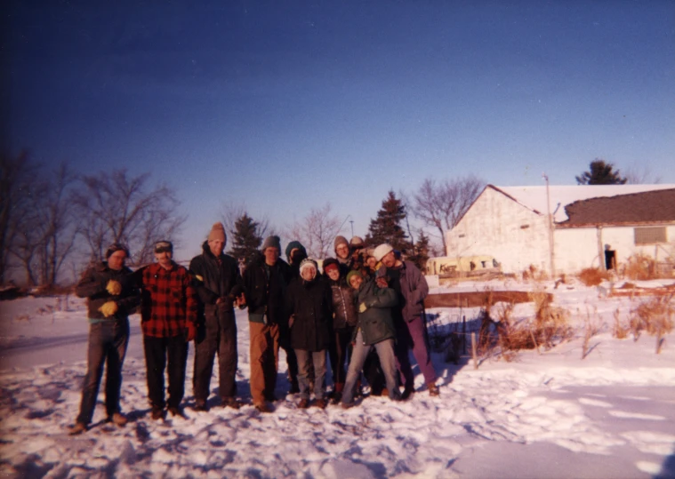 a group of men standing in the snow