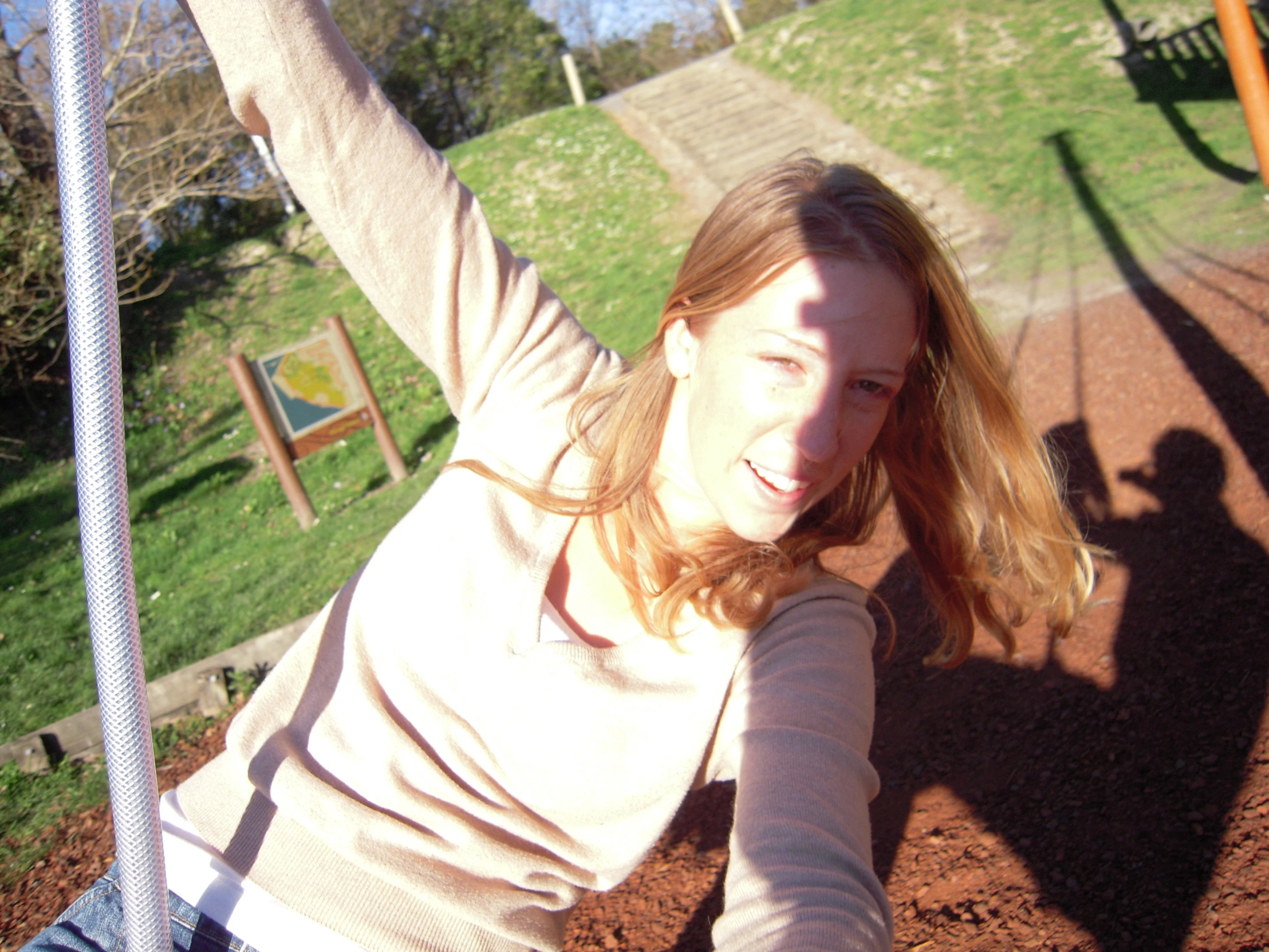 a woman holds her hands up in the air