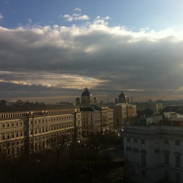 a view of some buildings and trees and the sky