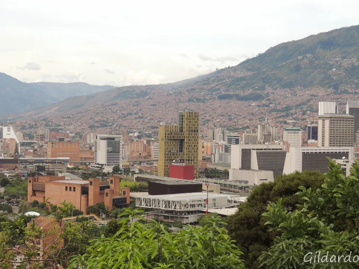 cityscape with mountains in the background in the day