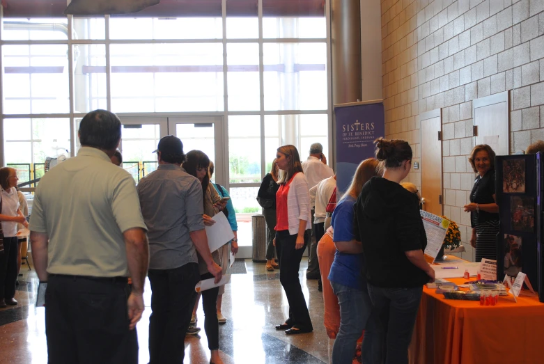 a group of people standing around at a convention