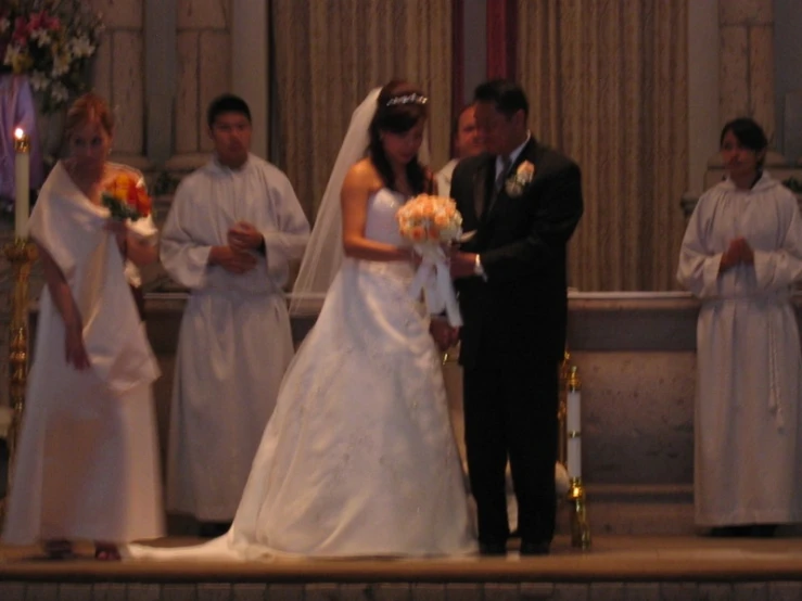 the bride and groom stand together in front of the alter at a wedding