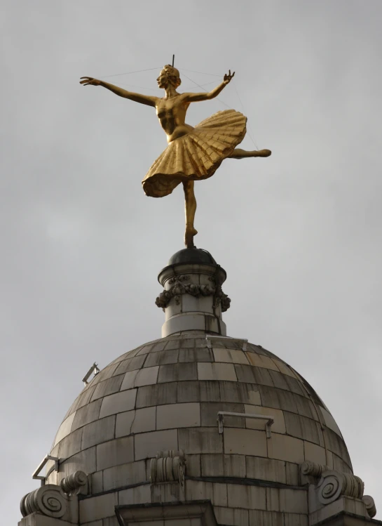 a statue of a woman with a yellow dress on