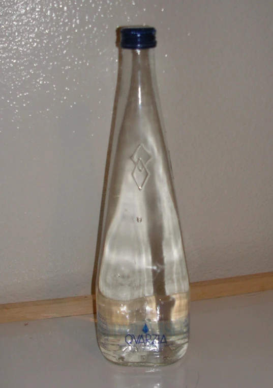 a water bottle with clear liquid on a table