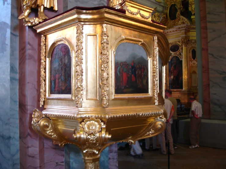 a small golden clock in a big room