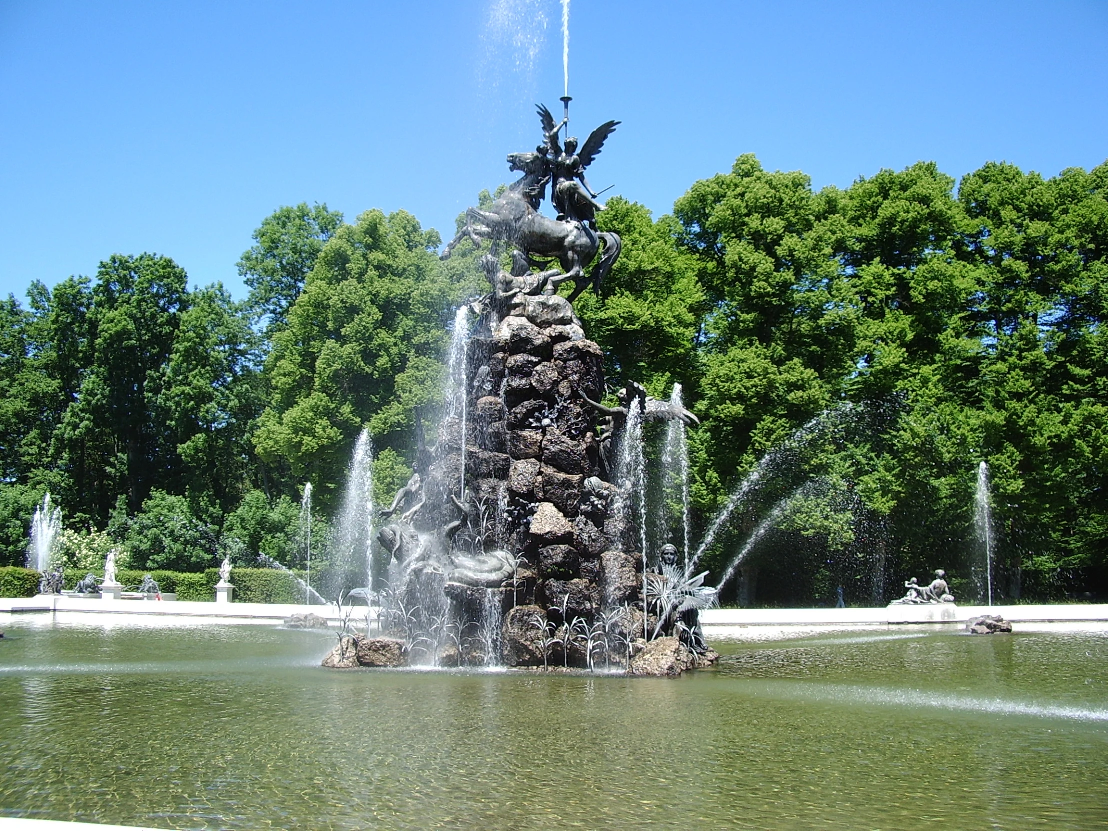 a bird sitting on top of a fountain