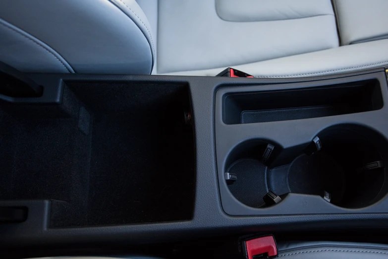 the interior of a car with cup holder in place