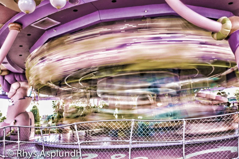 a blurry pograph of a carnival ride with many colorful things