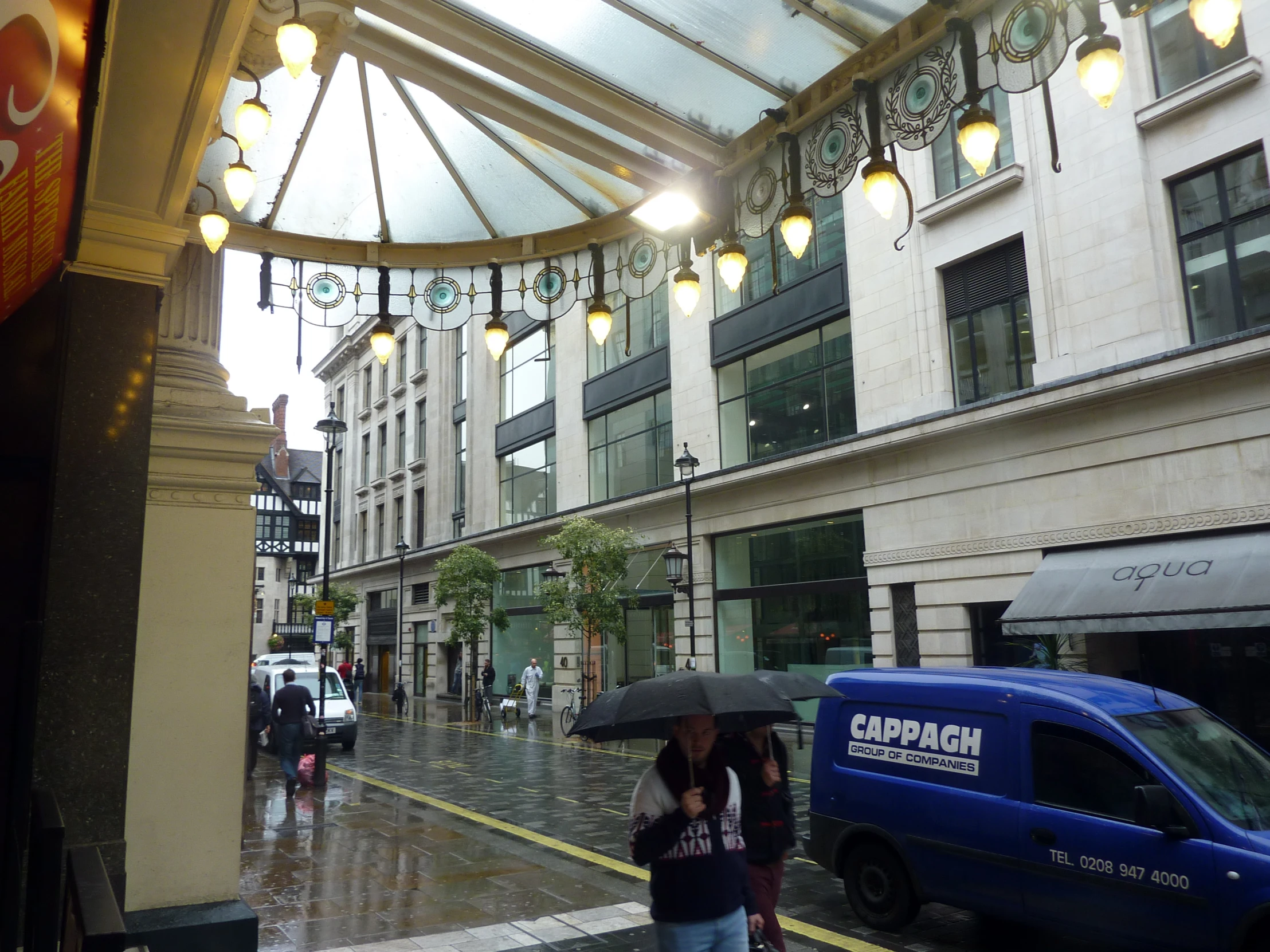 a couple of people with umbrellas on a rainy street