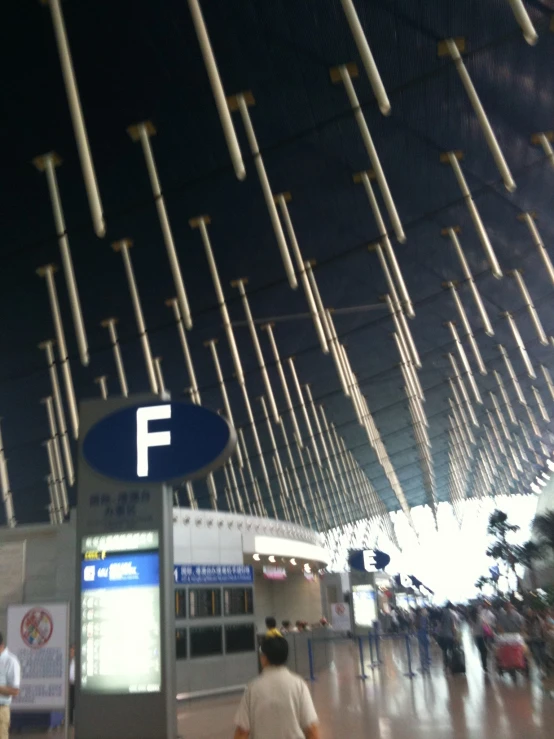 people walking through a terminal at an airport