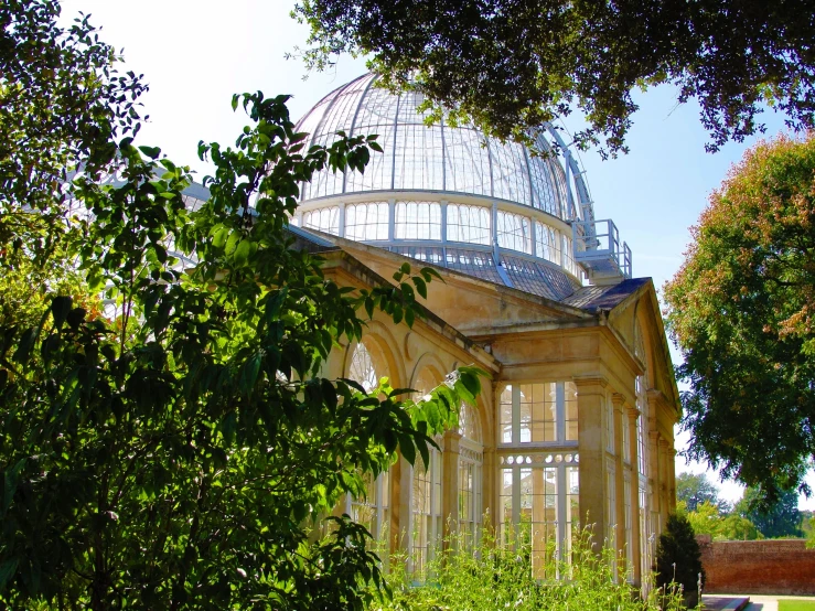 a gazebo with trees around it on a sunny day