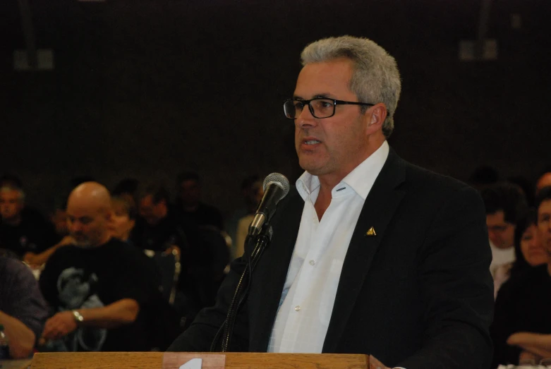 a man is giving a speech to a crowd